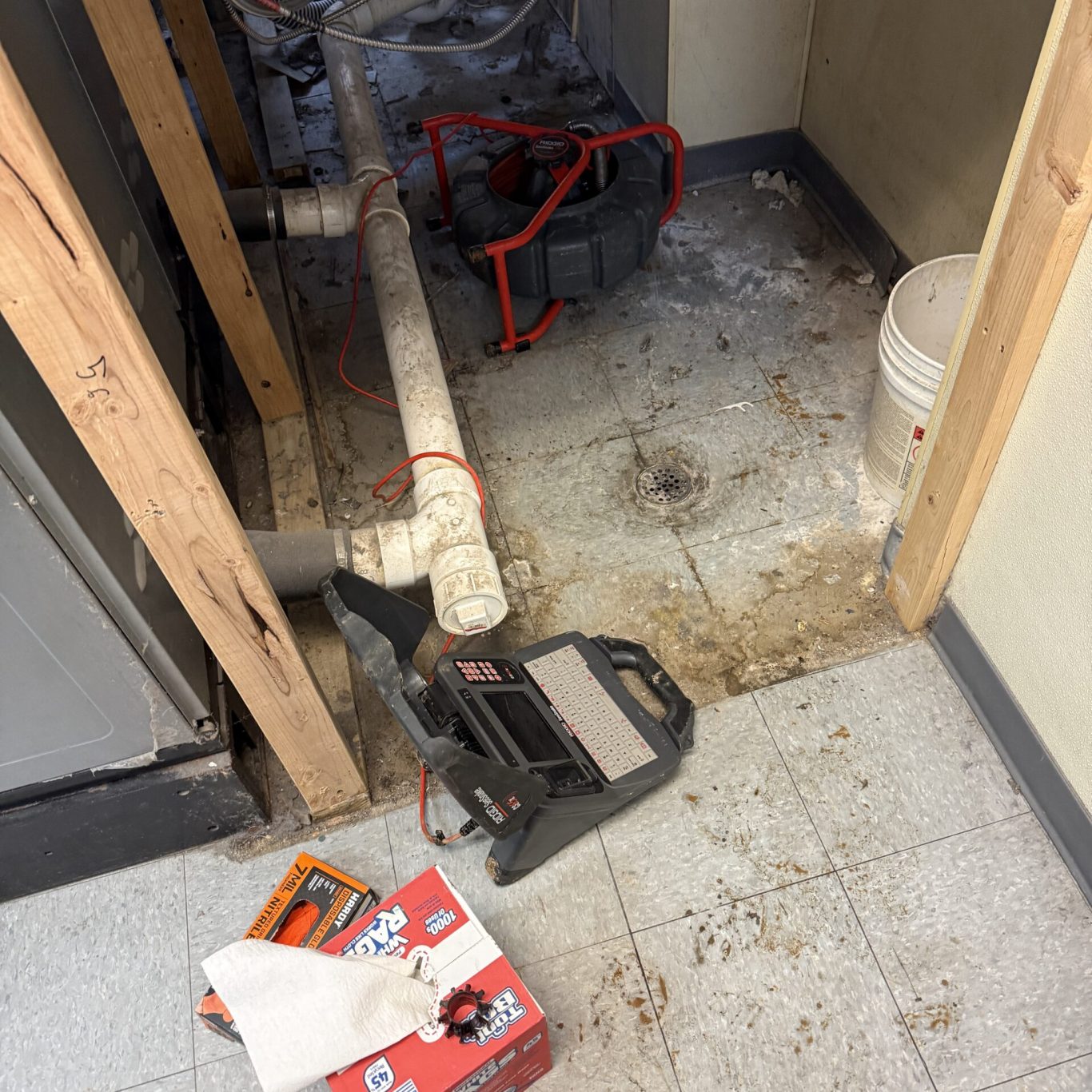 Experienced plumber using diagnostic camera to inspect underground drainage at Cumberland County residence