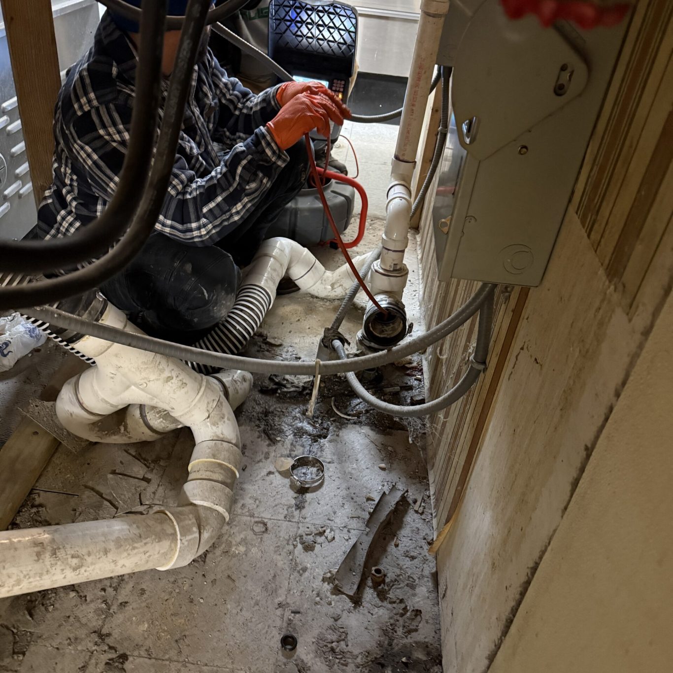 Technician providing dependable drainage service for a commercial property in Paxtonia, PA after storm flooding