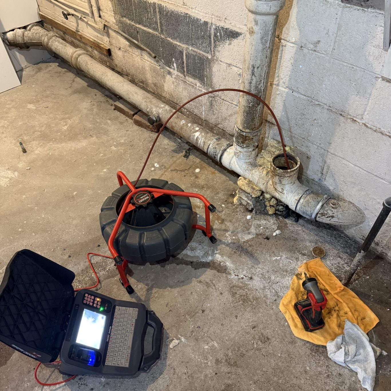 Technician using high-pressure jetter to clear blocked residential drain in Carlisle backyard