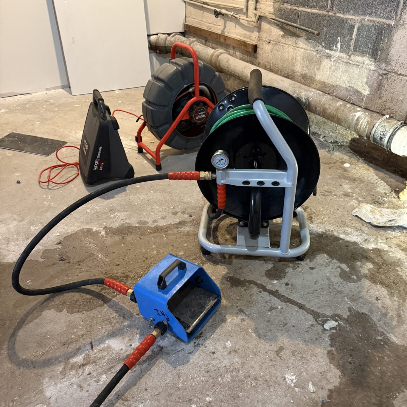 Technician clearing backed-up outdoor drain for a Dauphin County homeowner after heavy rain