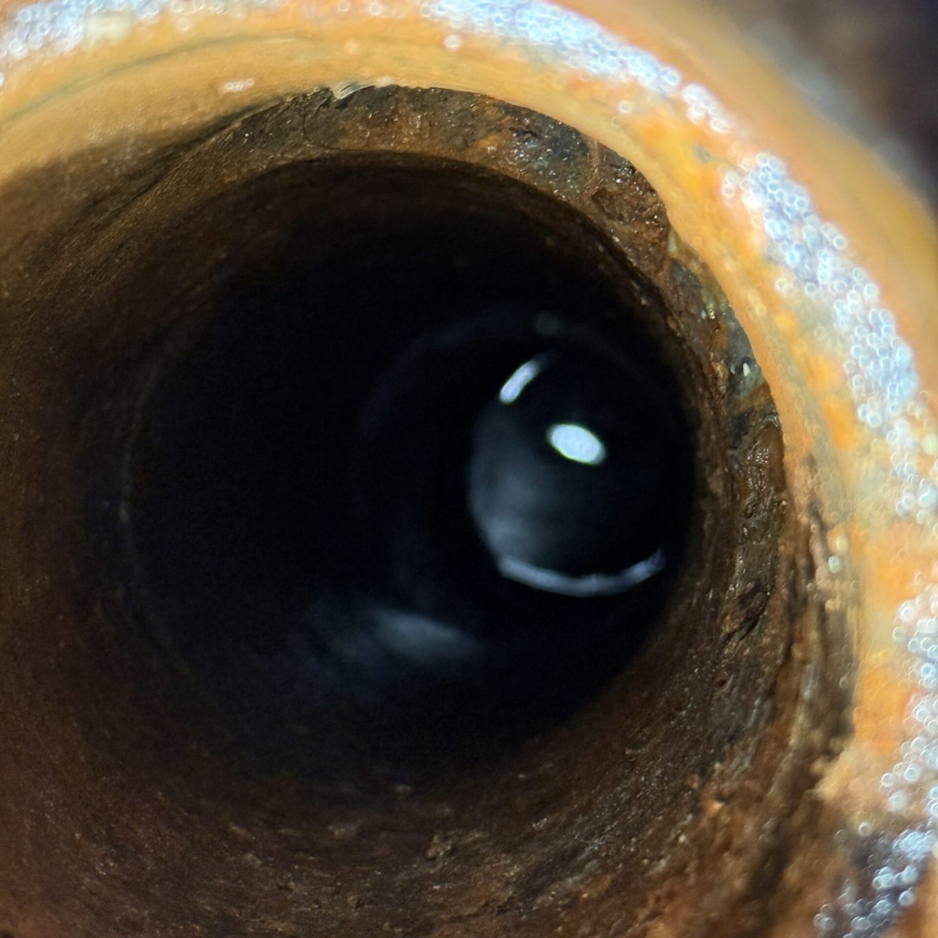Technician using hydro jetting equipment to clear a blocked kitchen drain in a Hershey, PA residence