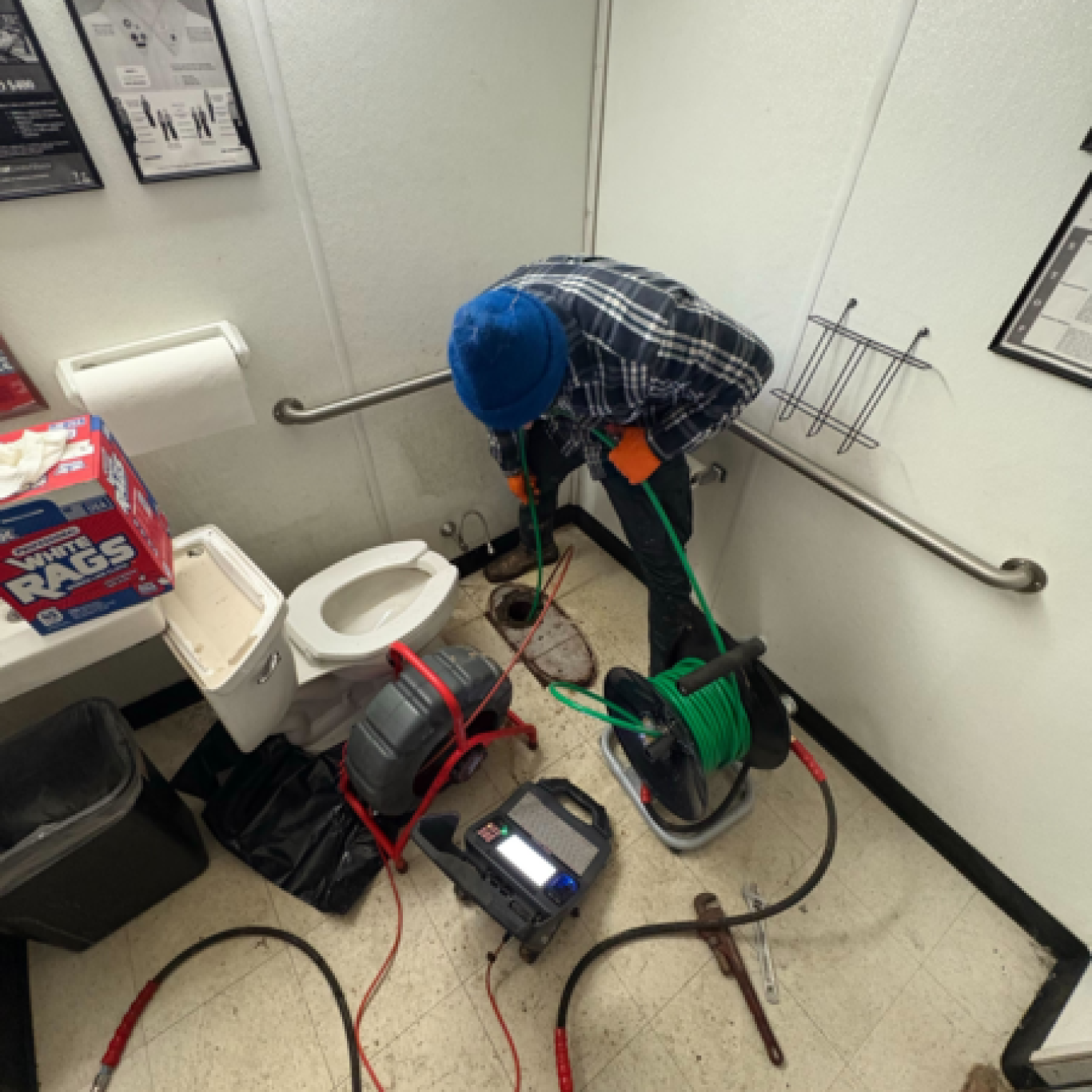 Skilled technician using hydro-jetting equipment to clear stormwater drains at a Hershey, PA commercial site
